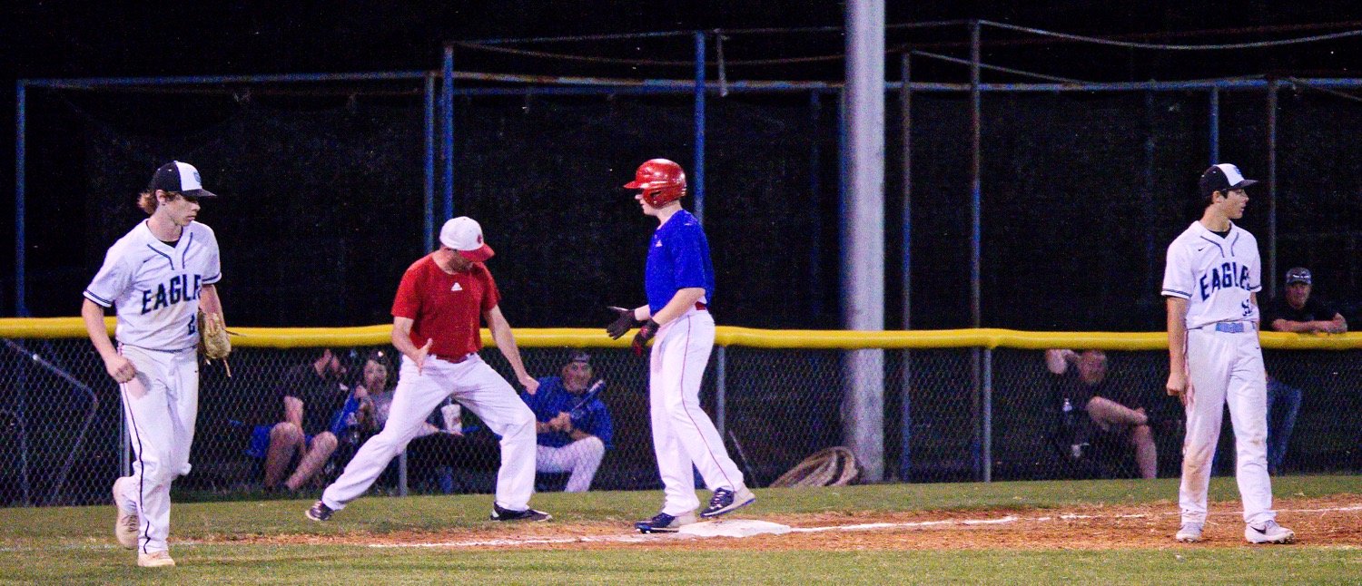 Hatch Campbell gets a celebratory low-five from Coach Oxford after hitting a triple.